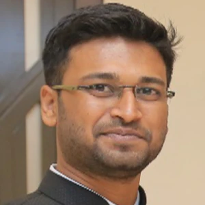 Well-groomed stylish young man with bow tie posing on dark background.