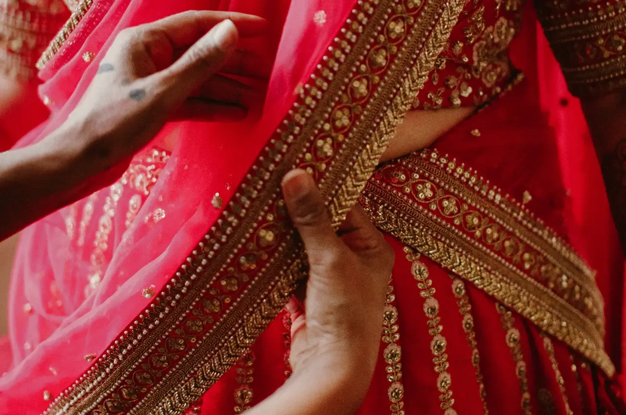 Well-groomed stylish young man with bow tie posing on dark background.