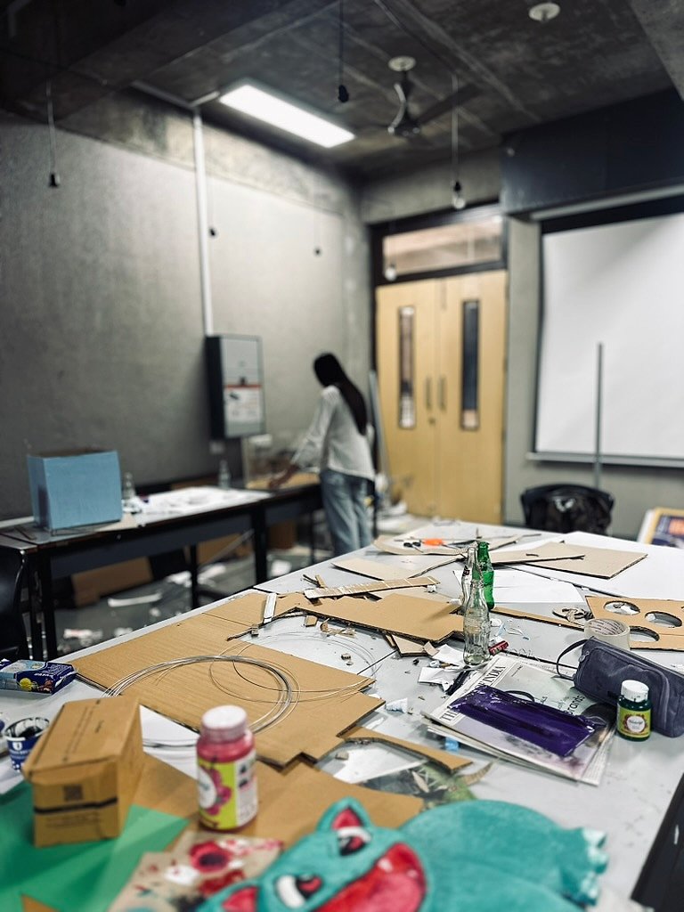 Messy studio table covered in materials