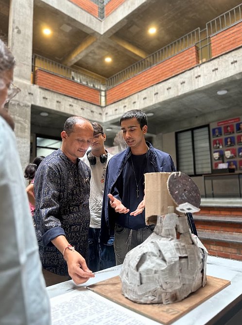 Mentor reviewing a student's sculptural model