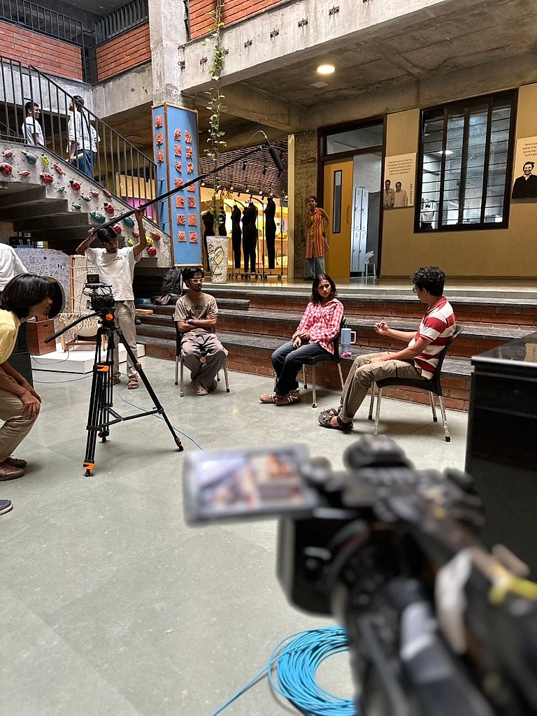 Film crew shooting an interview on the studio stairs