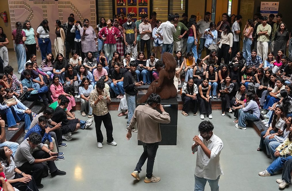 Students gathered around a sculpture in the atrium