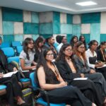 Inside a TV newsroom, from the assignment desk to the control room, toured by Parul University students